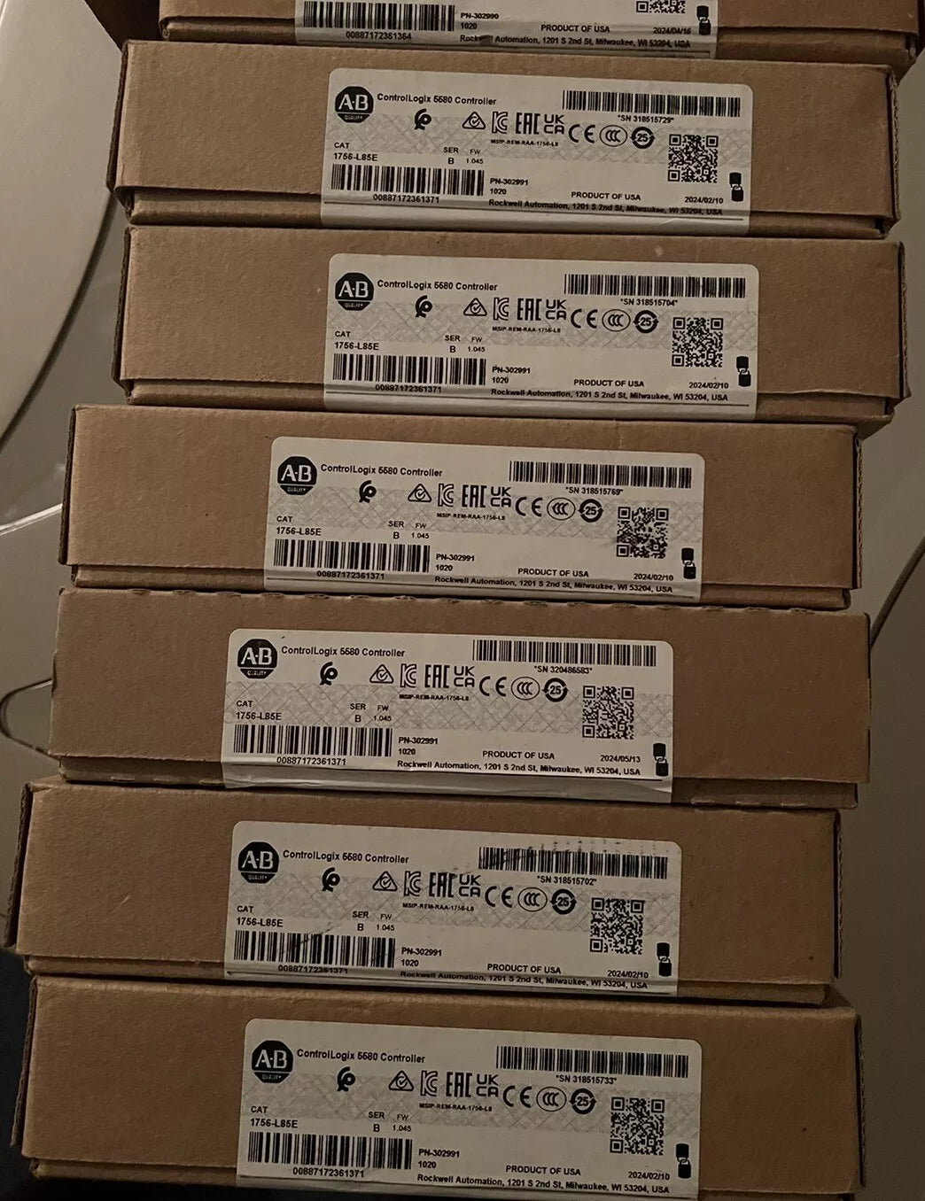 Stack of boxes containing Allen Bradley 1756-L85E industrial automation processor modules